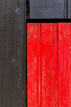 Red and black wooden wall with diferent color pattern.