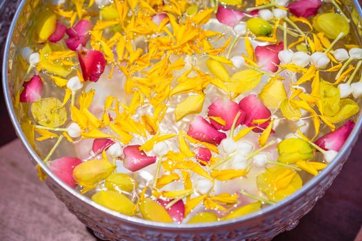 Floating flowers in aluminum bowl for festival in Thailand