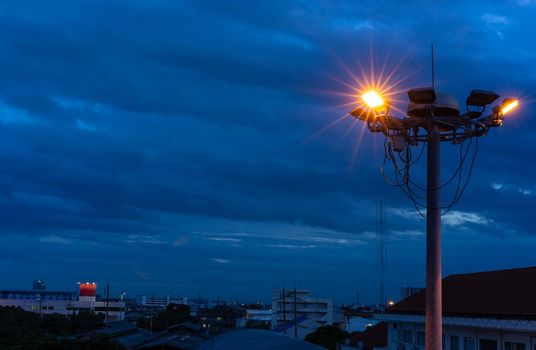 illuminate of some lamp on Spot-light tower over Blue Sky at night time