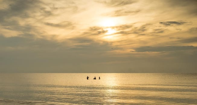 silhouette of fishermans with sunrise in the background