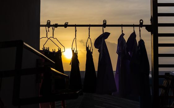 clothes hanging on the clothesline with sunset