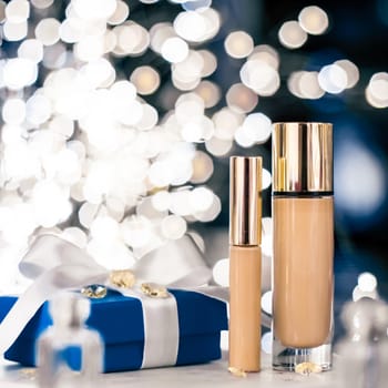 Cosmetic branding, Christmas glitter and girly blog concept - Holiday make-up foundation base, concealer and blue gift box, luxury cosmetics present and blank label products for beauty brand design