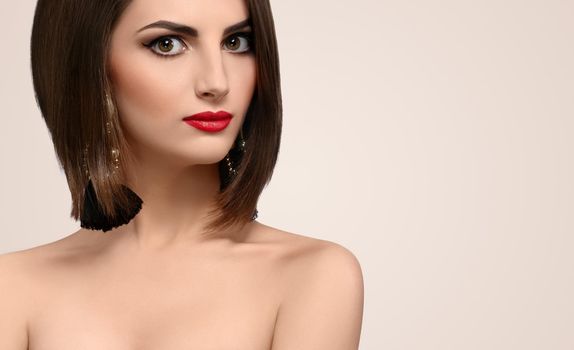 Gorgeous red lipped brunette with healthy shiny hair looking to the camera confidently copyspace elegance beauty cosmetics skincare perfection femininity concept