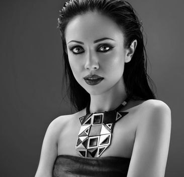 Silent beauty. Black and white portrait of a beautiful young female fashion model wearing smoky eyes makeup and dark lipstick posing sensually at studio copyspace shadow mystery fashion beauty