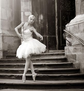 Committed to ballet. Monochrome outdoors shot of a gorgeous young woman dancing ballet