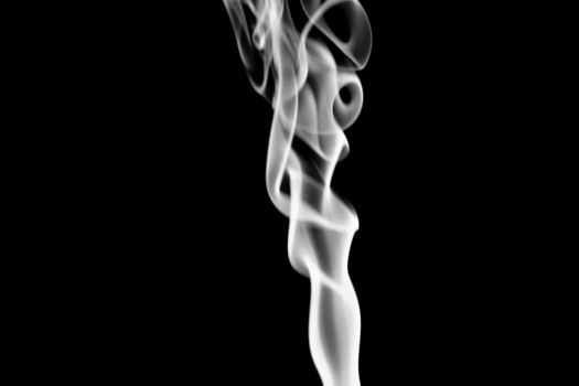 Incense cone shooting beautiful smoke on black background