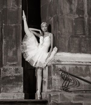 Artistic look. Monochrome portrait of a beautiful ballet dancer posing near the wall looking away thoughtfully soft focus picture