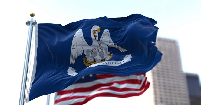 The flags of the Louisiana state and United States of America waving in the wind. Democracy and independence. American state.