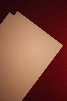 Blank A4 paper, beige on dark red background as office stationery flatlay, luxury branding flat lay and brand identity design for mockups