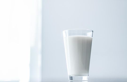 Dairy, healthy nutrition and breakfast concept - World Milk Day, full glass on marble table