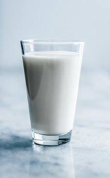 Dairy, healthy nutrition and breakfast concept - World Milk Day, full glass on marble table