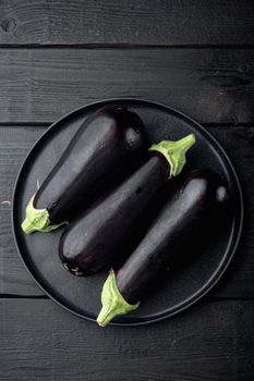 Eggplant, aubergine organic ripe whole vegetables set, on black wooden table background, top view flat lay