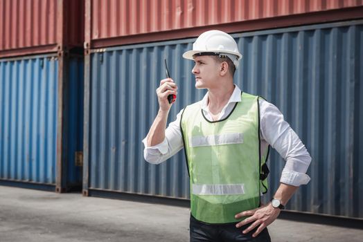Container Logistics Shipping Management of Transportation Industry, Transport Engineer Control Via Walkie-Talkie to Worker in Containers Shipyard. Business Cargo Ship Import/Export Factory Logistic.