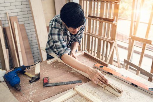 Carpenter Man is Working Timber Woodworking in Carpentry Shop, DIY Craftsman is Measuring Tape Furniture Wood in Workshop. Male Carpenter DIY Craft Work is Concentrated His Job, Labor Skill Builder