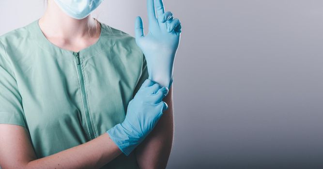 Medical Doctor in Personal Protective Equipment on Isolated Background, Closeup of Female Doctor is Wearing Face Mask and Medic Latex Gloves for Patient Care Hygiene in Hospital. Healthcare/Medicine