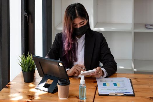 Woman freelance in quarantine for coronavirus working accounting financial from coffee shop.