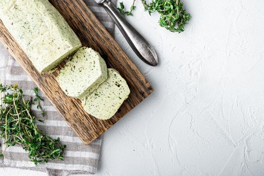 Fresh green herb butter set, on white stone background, with copy space for text