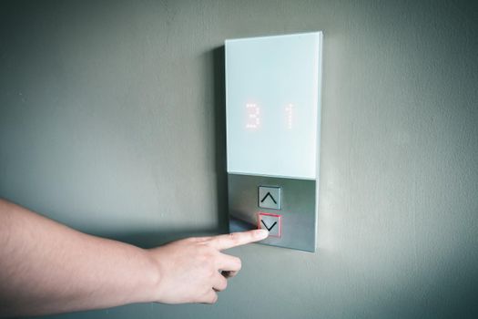 Closeup of Woman Hand is Pressing Elevator Button for Access to Office Building, Electrical Lift Buttons Control for Moving Up or Down Floor Level inside Buildings. Facility Electric Elevator Panel 