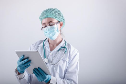 Medical Surgical Doctor and Health Care, Portrait of Surgeon Doctor in PPE Equipment on Isolated Background. Medicine Female Doctors Wearing Face Mask and Cap for Patients Surgery Work. Medic Hospital