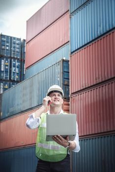 Container Logistics Shipping Management of Transportation Industry, Transport Engineer Managing Control Via Computer Laptop in Containers Shipyard. Business Cargo Ship Import/Export Factory Logistic.