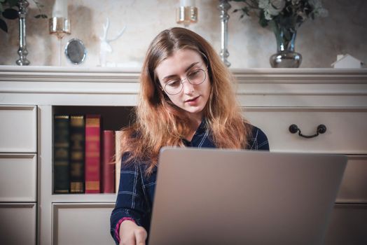 Young Woman Working on Computer Laptop at Home, Businesswoman in Busy Work While Online Conference Virtual Conversation on Laptop From Home. Technology Communication and Creative at Home Concept