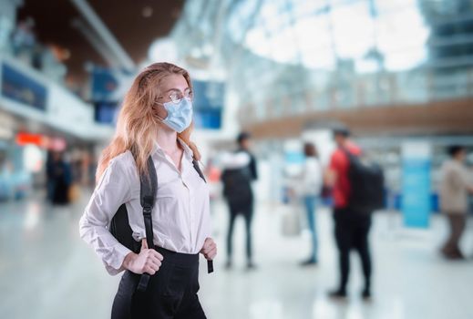 Tourist Woman With Protection Face Mask at The Airport Terminal in Coronavirus Covid-19 Pandemic, Defensive Measure for Travel Restrictions of Tourist During Covid 19 Outbreak. Healthcare/Medical