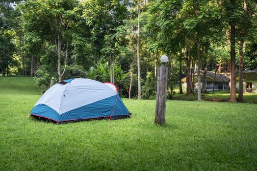 Camping Campsite and Tent on Green Grass Under The Trees Tropical Forest, Field Campground for Vacation Outdoors Leisure Activity and Adventure. Backpack Trekking Tourist Lifestyles, Travel Adventures