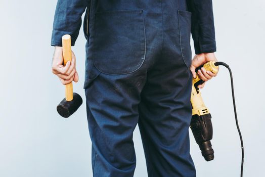 Construction Worker Holding Constructing Equipment Tools on Isolated Background. Carpenter Man Builder Real Estate Jobs Occupation, Business Engineering Industry and Building Development Concept.