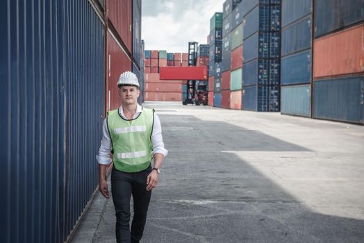Container Ship Logistics Engineer Worker is Working in Yard Shipping Terminal, Business Cargo Transport and Commercial Dock of Transportation Industry. Engineering Control of Containers Shipment
