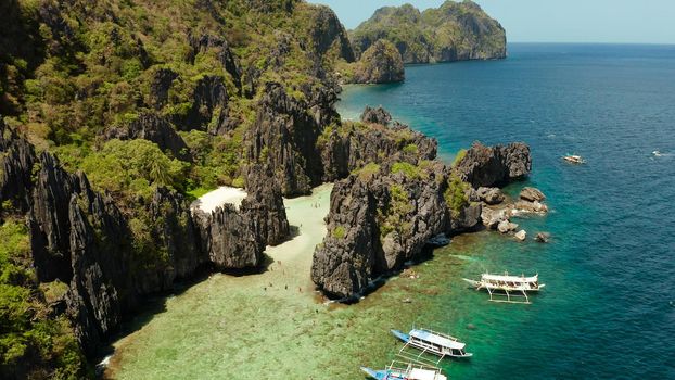 aerial view of tropical lagoon with sandy beach surrounded by cliffs. El nido, Philippines, Palawan. beautiful lagoon and karst scenery.