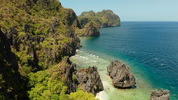 aerial view of tropical lagoon with sandy beach surrounded by cliffs. El nido, Philippines, Palawan. beautiful lagoon and karst scenery.