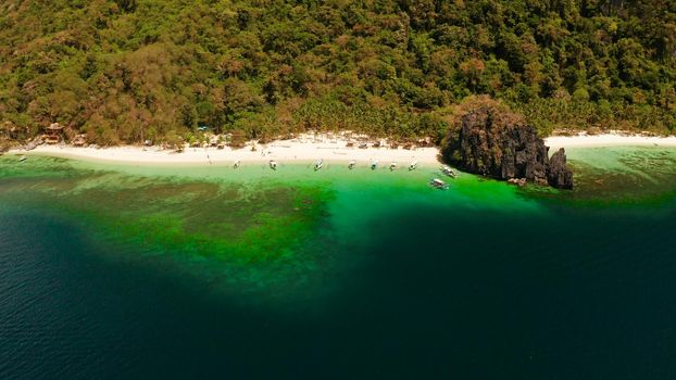 Tropical lagoon with sandy beach, aerial view. El nido, Philippines, Palawan. Seascape with tropical rocky islands, ocean blue water. Summer and travel vacation concept