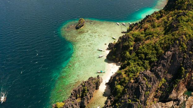 aerial view tropical lagoon with sandy beach surrounded by cliffs. El nido, Philippines, Palawan. beautiful lagoon and karst scenery.