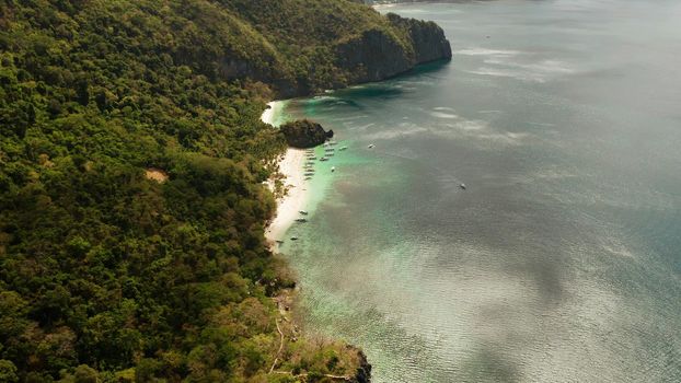 Tropical lagoon with sandy beach, aerial view. El nido, Philippines, Palawan. Seascape with tropical rocky islands, ocean blue water. Summer and travel vacation concept