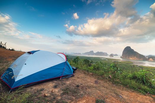 Camping Tent and Resting Area at Campsite on Nature Seascape Background, Family Vacation and Outdoor Leisure Activity Camp Fire in National Park. Natural Adventure Backpacking and Holiday Trip.