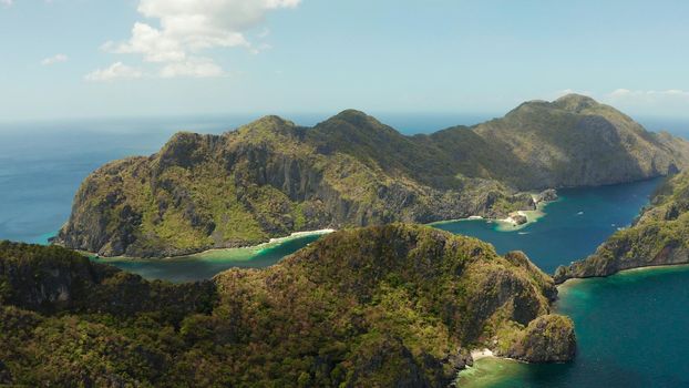 Seascape with tropical rocky islands, ocean blue water, aerial view . islands and mountains covered with tropical forest. El nido, Philippines, Palawan. Tropical Mountain Range