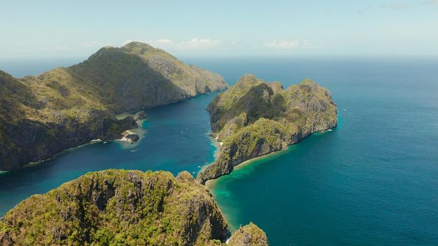 Bay and the tropical islands. Seascape with tropical rocky islands, ocean blue wate, aerial view. islands and mountains covered with tropical forest. El nido, Philippines, Palawan. Tropical Mountain Range