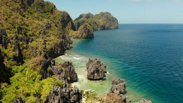 Tropical lagoon with sandy beach surrounded by cliffs. El nido, Philippines, Palawan. beautiful lagoon and karst scenery.