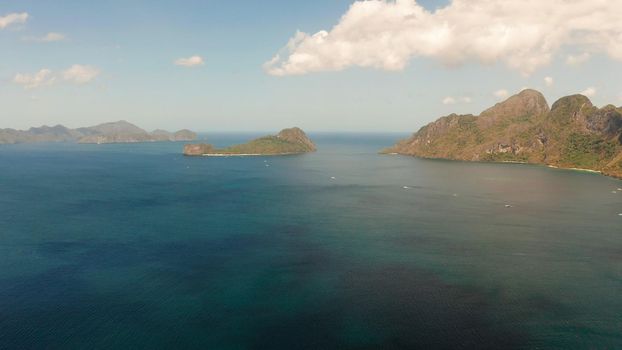 Bay and the tropical islands. Seascape with tropical rocky islands, ocean blue wate, aerial view. islands and mountains covered with tropical forest. El nido, Philippines, Palawan. Tropical Mountain Range
