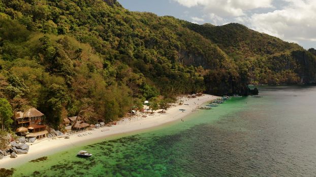 Tropical lagoon with sandy beach, aerial view. El nido, Philippines, Palawan. Seascape with tropical rocky islands, ocean blue water. Summer and travel vacation concept