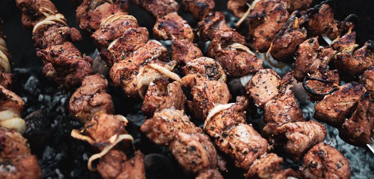 Shashlik cooking concept. Close-up of grilling tasty dish on barbecue. Grilling shashlik on barbecue grill