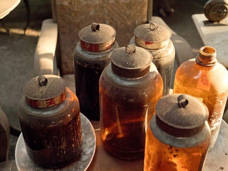 Antique street shop with old glass vessels, bottles, vintage items in Bali.