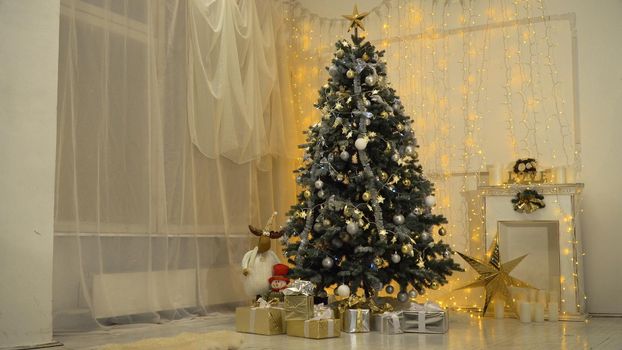 Decorated christmas tree with colorful balls and gifts. Christmas and New Year decorated interior room with presents and New year tree.