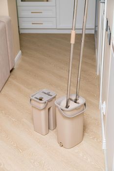 Modern buckets with mops. Cleaning of premises. Close-up