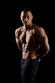 He knows how to push his limits. Vertical shot portrait of a shirtless fitness man showing off his strong muscular body looking to the camera