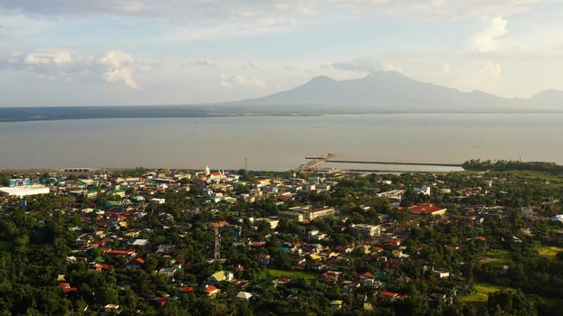 Sorsogon City, Luzon, Philippines. Town by the sea, top view. Landscape in Asia. Summer and travel vacation concept. View of a small town and a volcano in the distance.