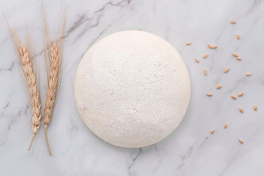 Fresh raw homemade yeast dough resting on marble table flat lay.