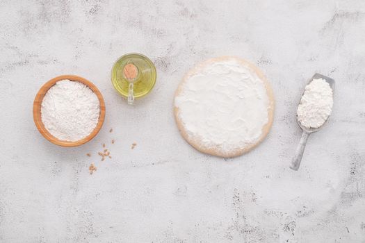 The ingredients for homemade pizza dough with wheat ears ,wheat flour and wheat grains set up on white concrete background.