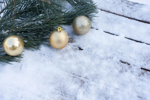 Winter background. Empty wooden plank with snowy border with pine branch and christmas ball decoration, copy space for text Wood table to. For product display Christmas time mock up