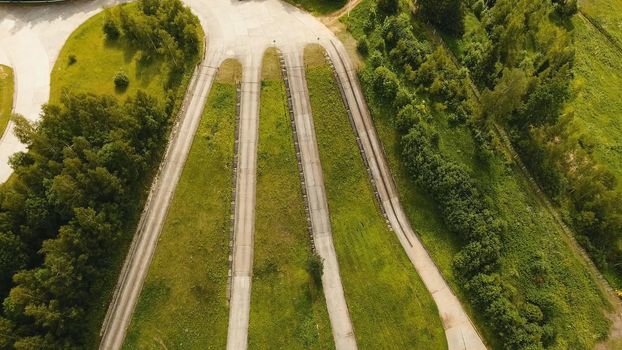 Aerial view Road for a drive test drive, climb up the slope. Simulation of climbing uphill for vehicle testing.Test road in the forest for testing and fine-tuning cars.
